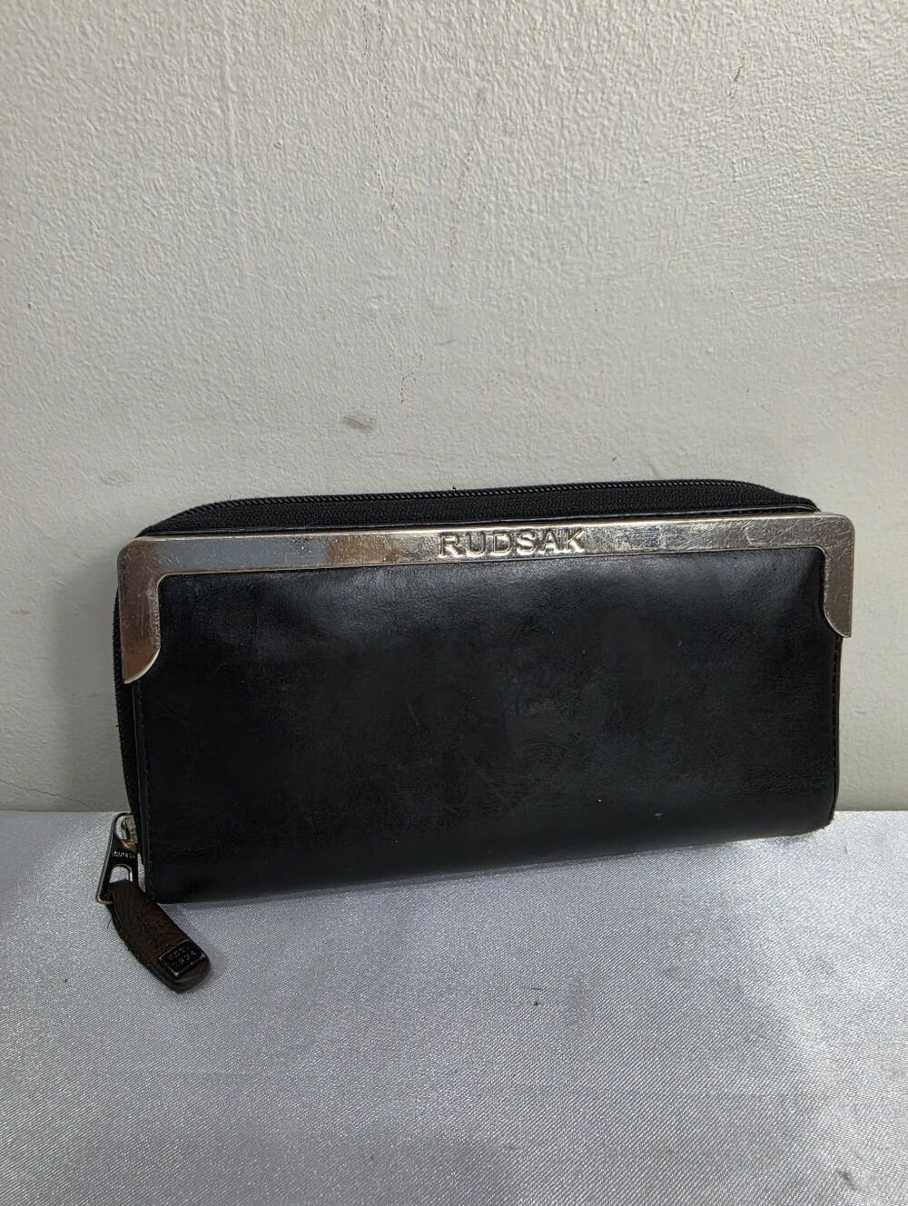 RUDSAK Black Leather Zip-Around Wallet with Metal Trim